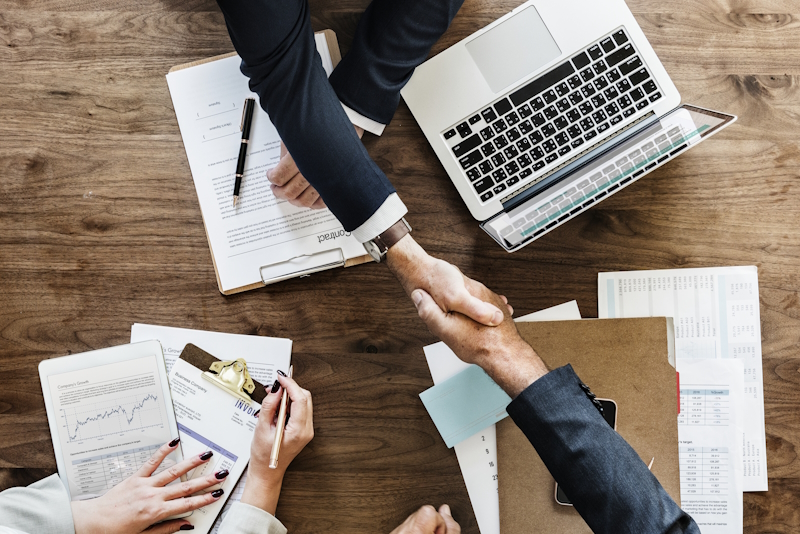 Business people shaking hands together